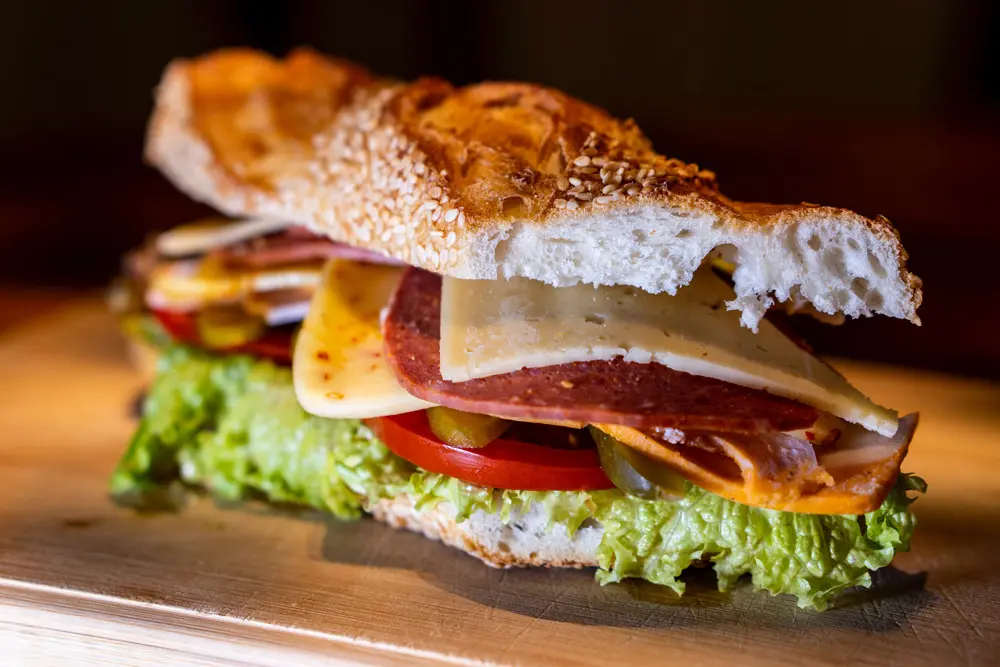 Crispy Sandwich with Lettuce and Tomato on a Cutting Board